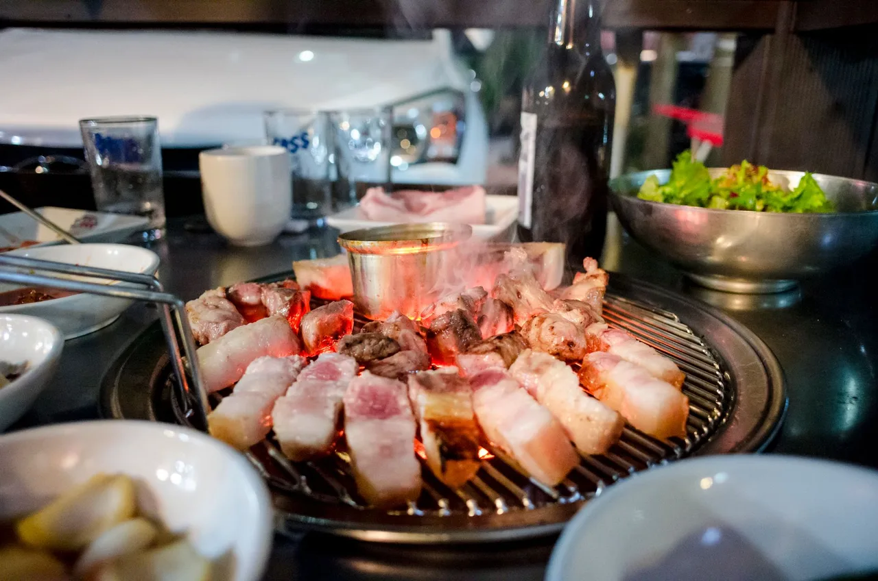 Samgyeopsal pork grilling on a Korean BBQ table