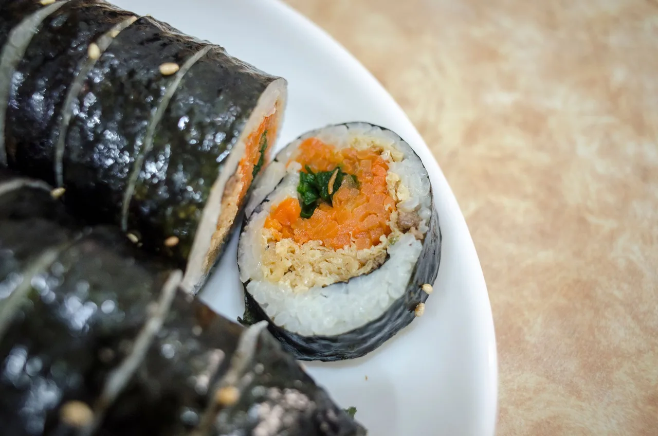 Rolls of vegetable gimbap sliced on a plate