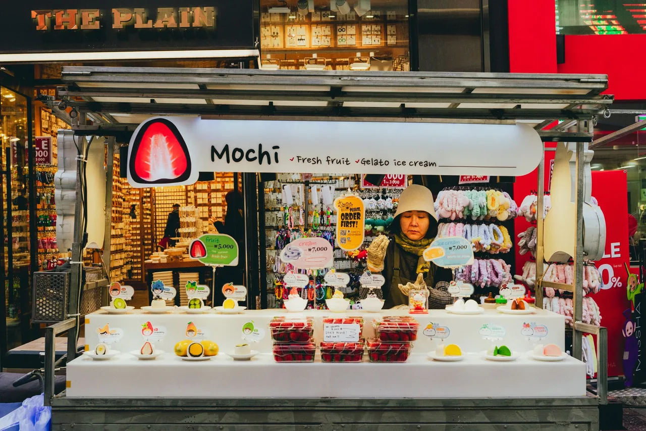 Street food carts lining Myeongdong after dark